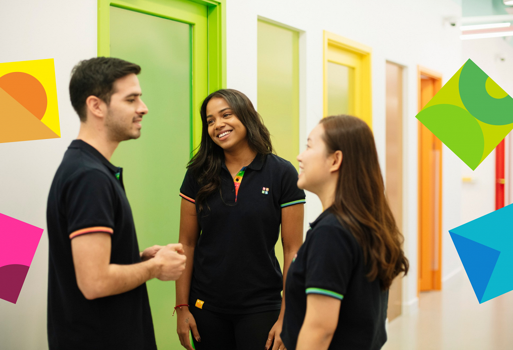 teaching staff chatting outside a classroom