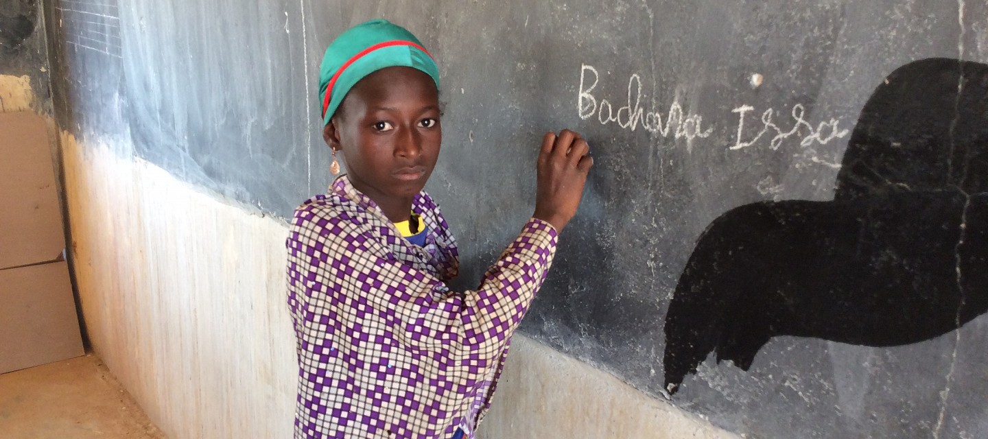 Girl writing on board in Niger