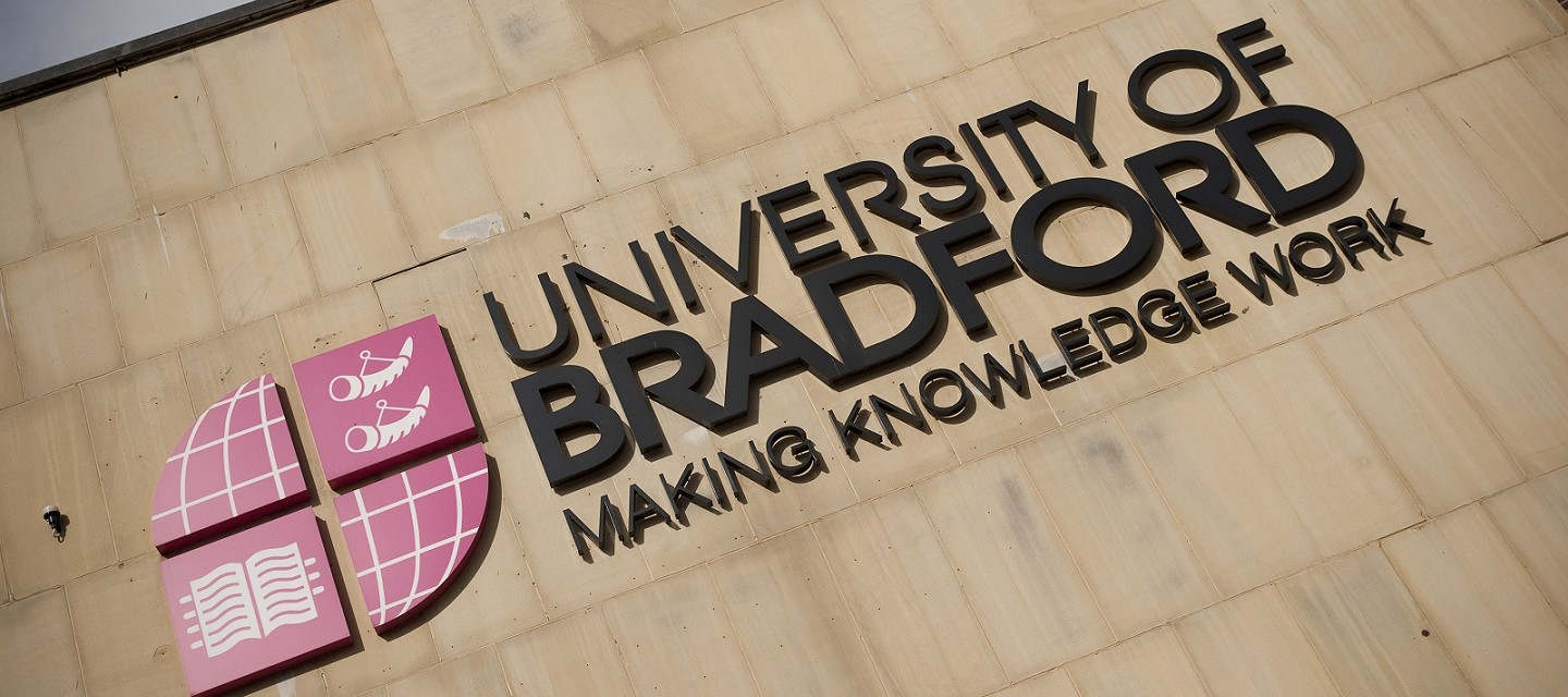 University of Bradford logo on a wall.