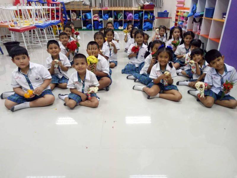 Thai students sitting on floor